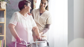 BKK VBU Pflegeportal ambulante Pflegeleistungen: Frau mit Gehilfe und Betrueuung durch Pflegerin